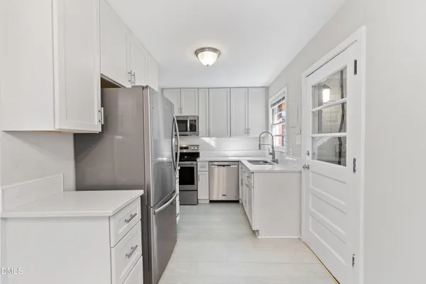 a kitchen with a sink stove and cabinets