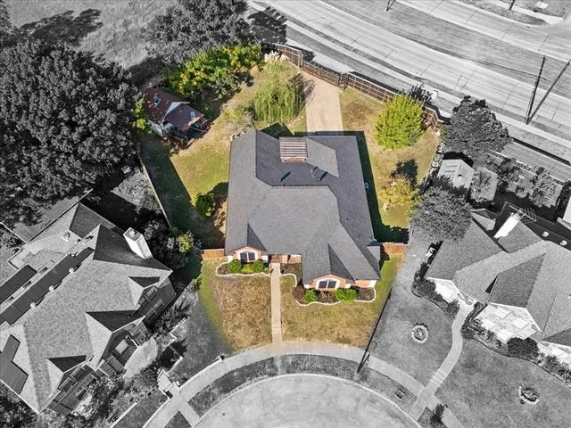 an aerial view of a house with a swimming pool