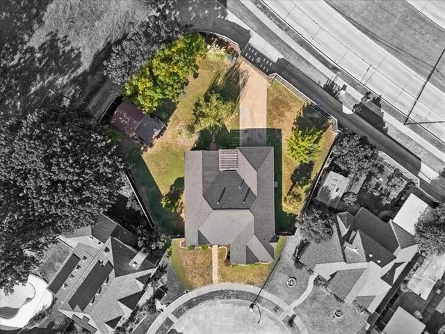 an aerial view of a house with a garden and swimming pool