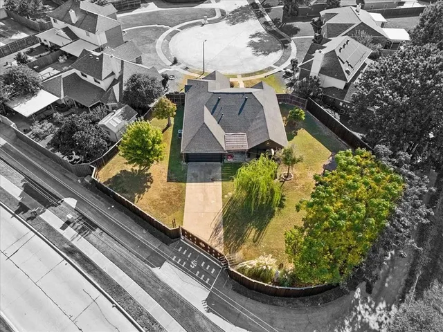 an aerial view of residential houses with outdoor space