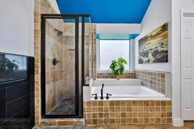 a bathroom with a bathtub and a shower
