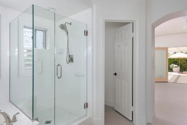 a bathroom with a glass shower door