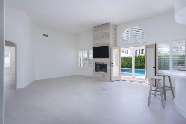 a view of livingroom with furniture fireplace and window