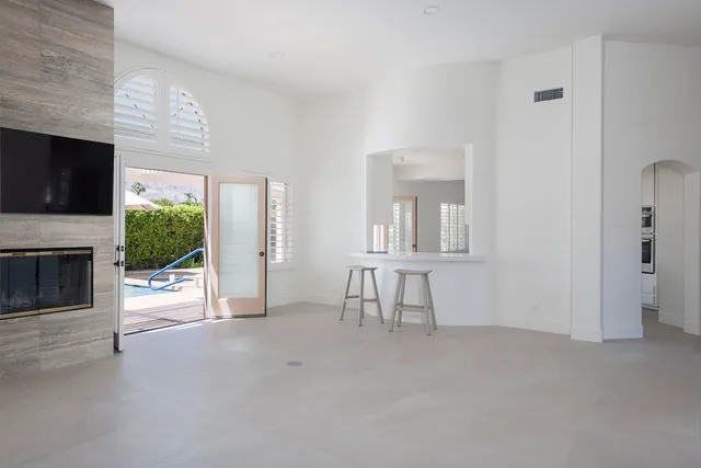a view of livingroom with furniture fireplace and window