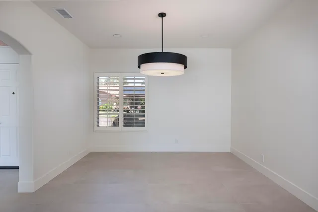 a kitchen that has a chandelier fan and a window