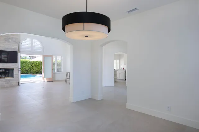 a view of a hallway with a ceiling fan and a window