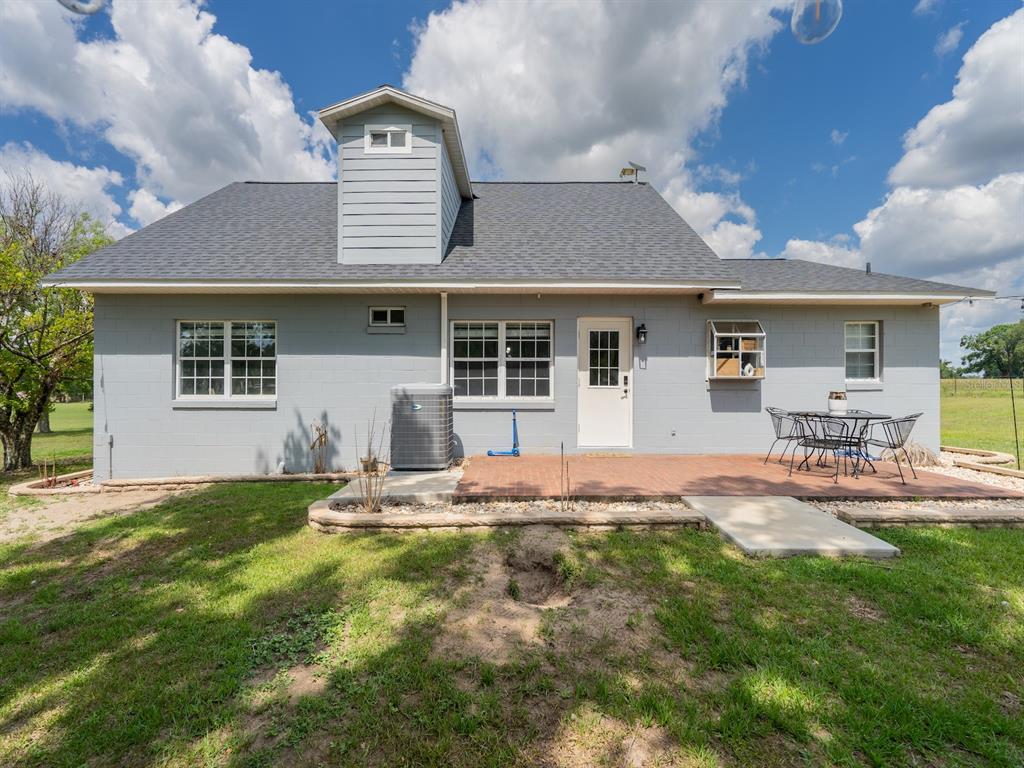4381 Northeast 105th Place Anthony, FL 32617 - Photo 35 of 49 a front view of a house with garden and patio