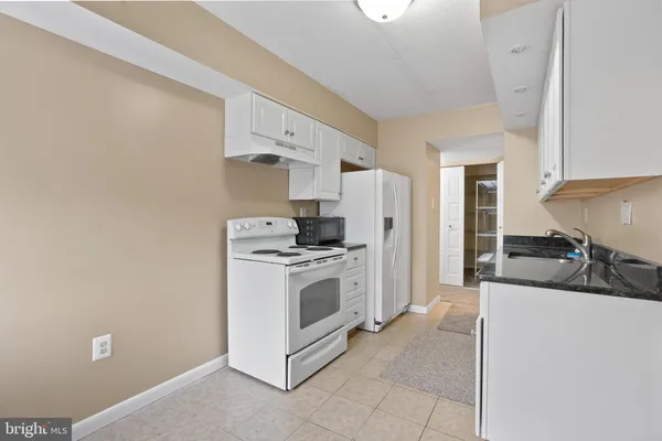 a kitchen with stainless steel appliances a stove a sink and a refrigerator
