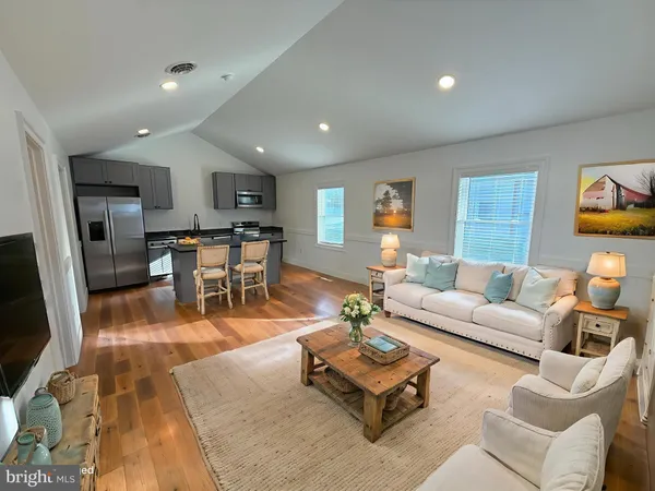 a living room with furniture and kitchen view