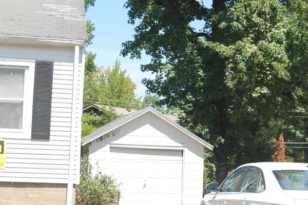 a view of house with a tree in front