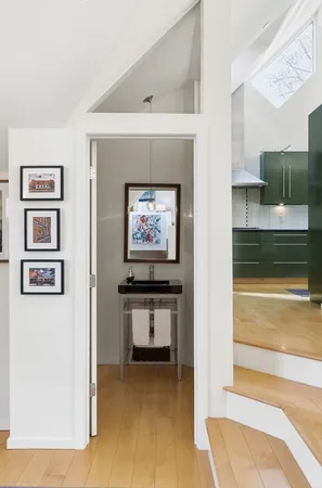 a view of a hallway with paintings on the wall