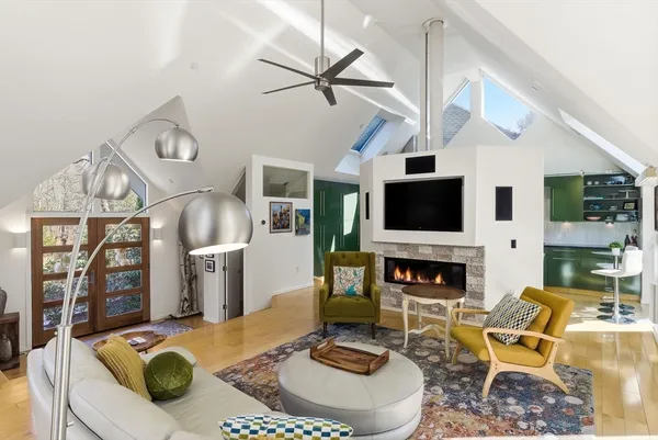 a living room with furniture a flat screen tv and a fireplace