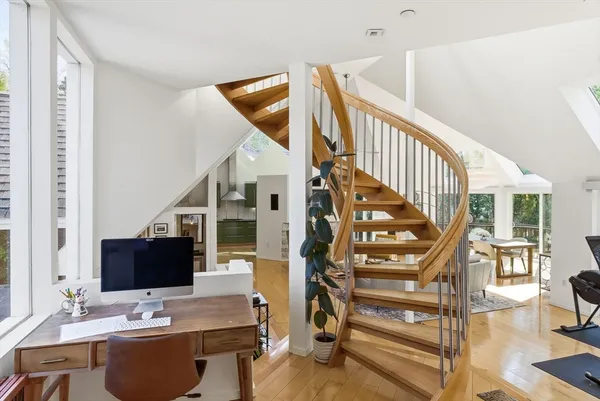 a view of staircase with white walls and a chandelier