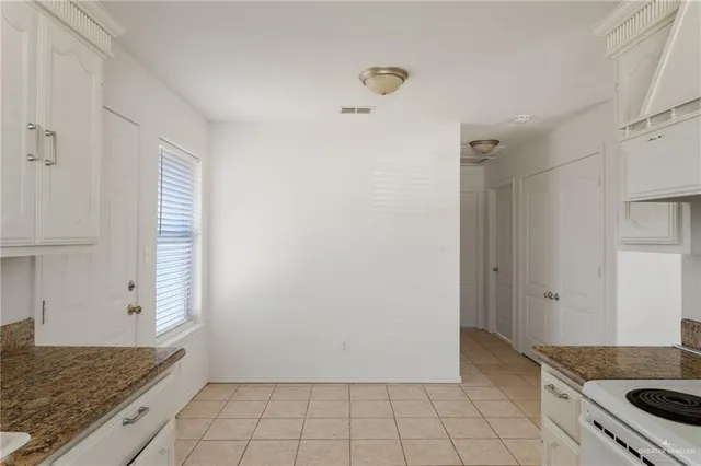 a kitchen with a stove and a refrigerator