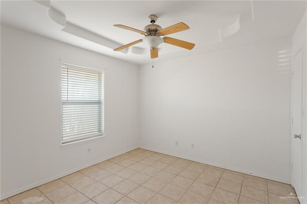 705 West Bronze Drive, Unit 3 Pharr, TX 78577 - Photo 9 of 13 an empty room with ceiling fan and window