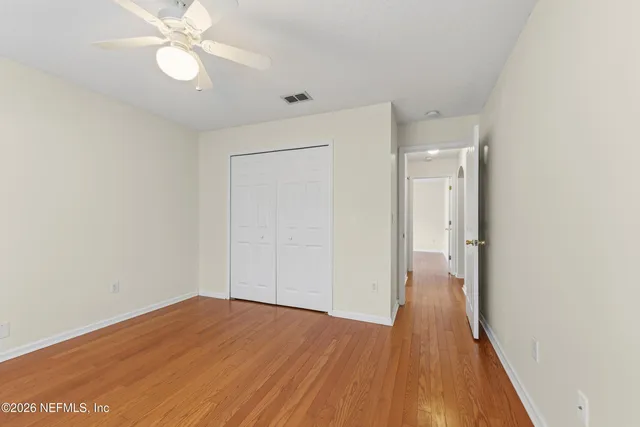 a view of a room with wooden floor and door