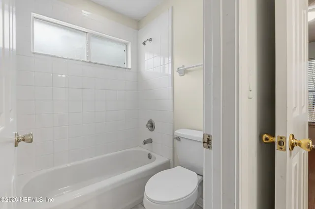 a bathroom with a toilet and a bathtub