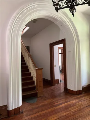 a view of entryway and hall with wooden floor