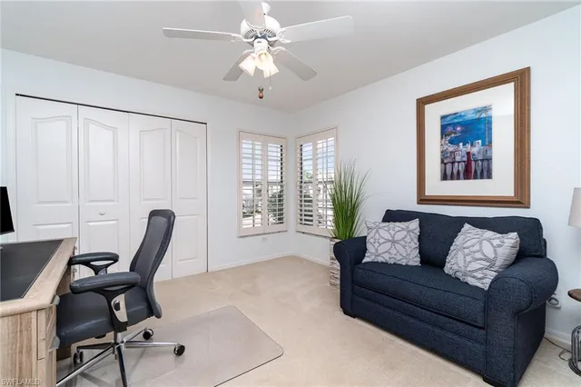 a living room with furniture a chandelier and a window