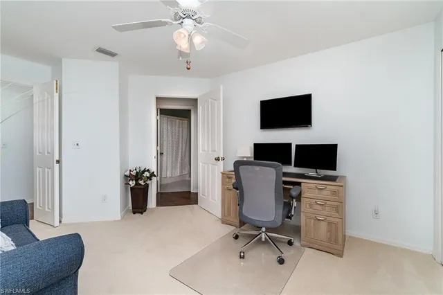 a view of a livingroom with workspace and a couch