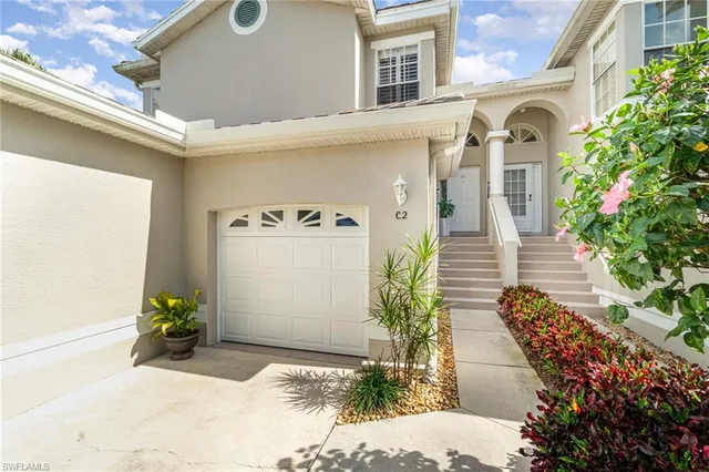 a view of a house with potted plants