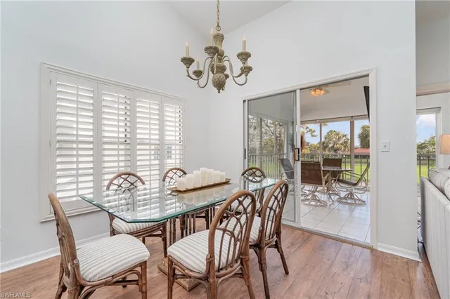 a view of a dining room with furniture wooden floor and a chandelier