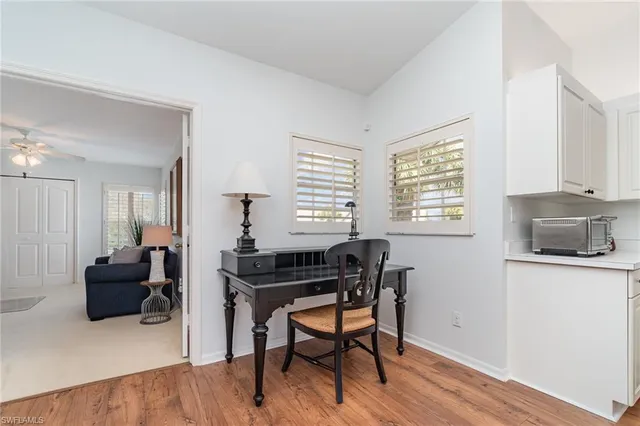 a view of a livingroom with furniture and a window