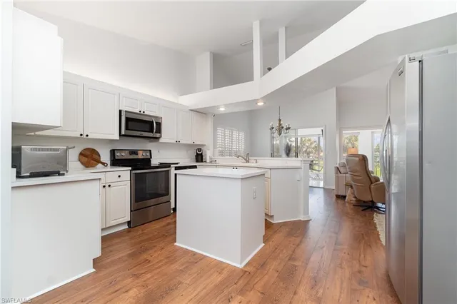 a kitchen with a sink cabinets and wooden floor