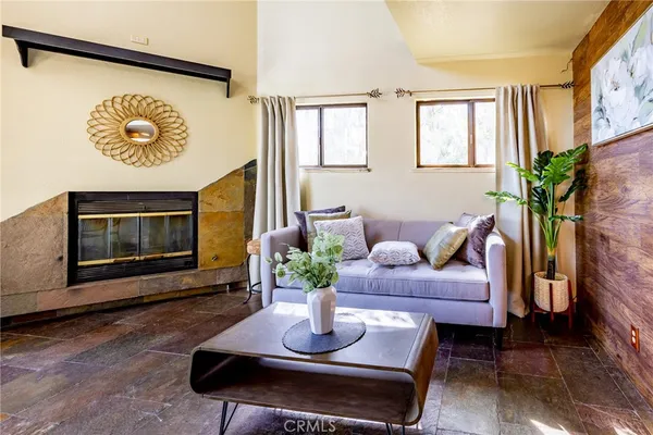 a living room with furniture potted plant and a window