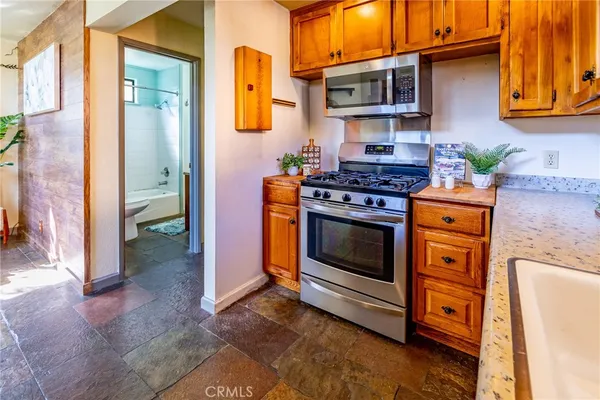 a kitchen with stainless steel appliances granite countertop a stove and a refrigerator