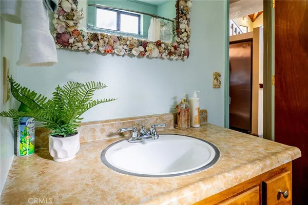 a bathroom with a sink a vanity and a mirror