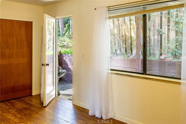 a view of an entryway with wooden floor and door