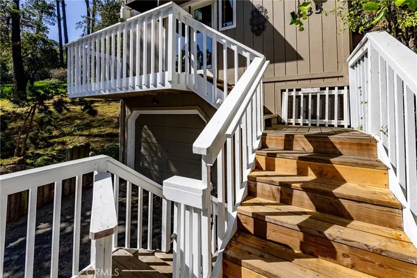a view of a building with stairs and a bench