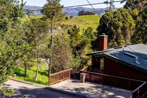 a view of balcony with wooden floor and fence