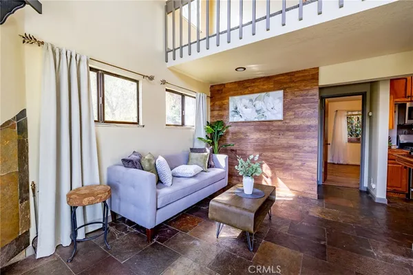 a living room with furniture wooden floor and a flat screen tv