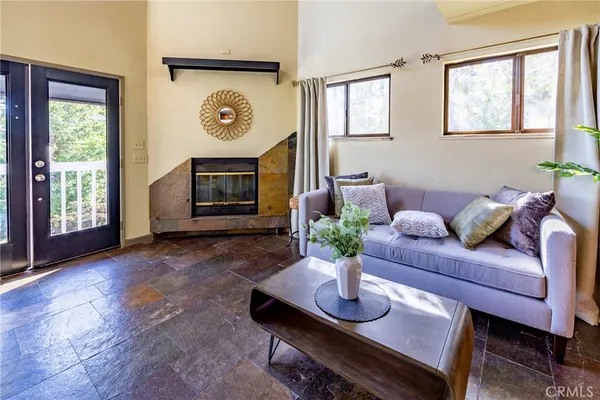 a living room with furniture a window and a fireplace