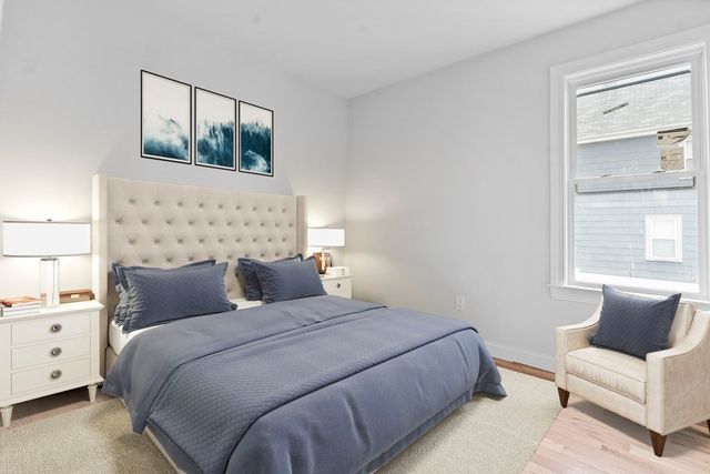 a bedroom with a bed couch and window