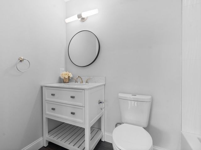 a bathroom with a toilet a sink and mirror