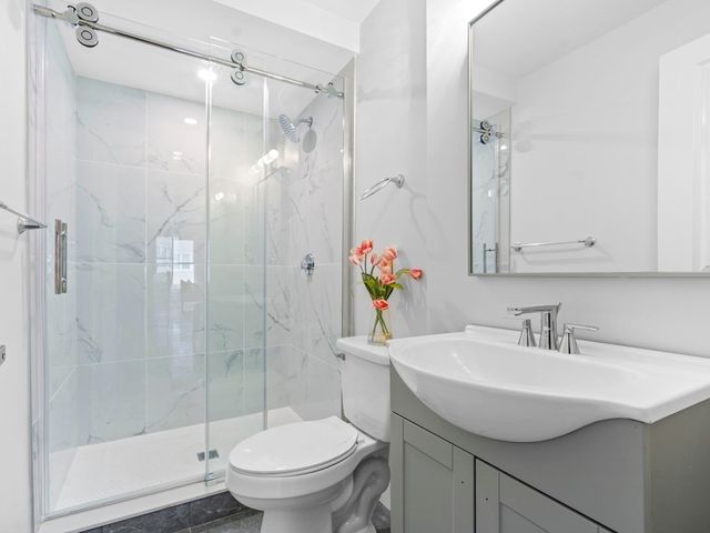 a bathroom with a sink toilet and shower