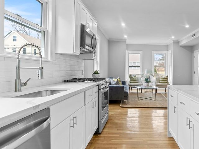 a kitchen with a sink stove top oven and refrigerator