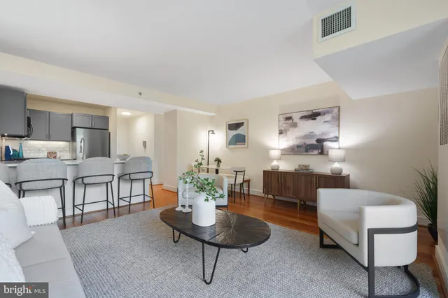 a large bed sitting in a bedroom next to a window