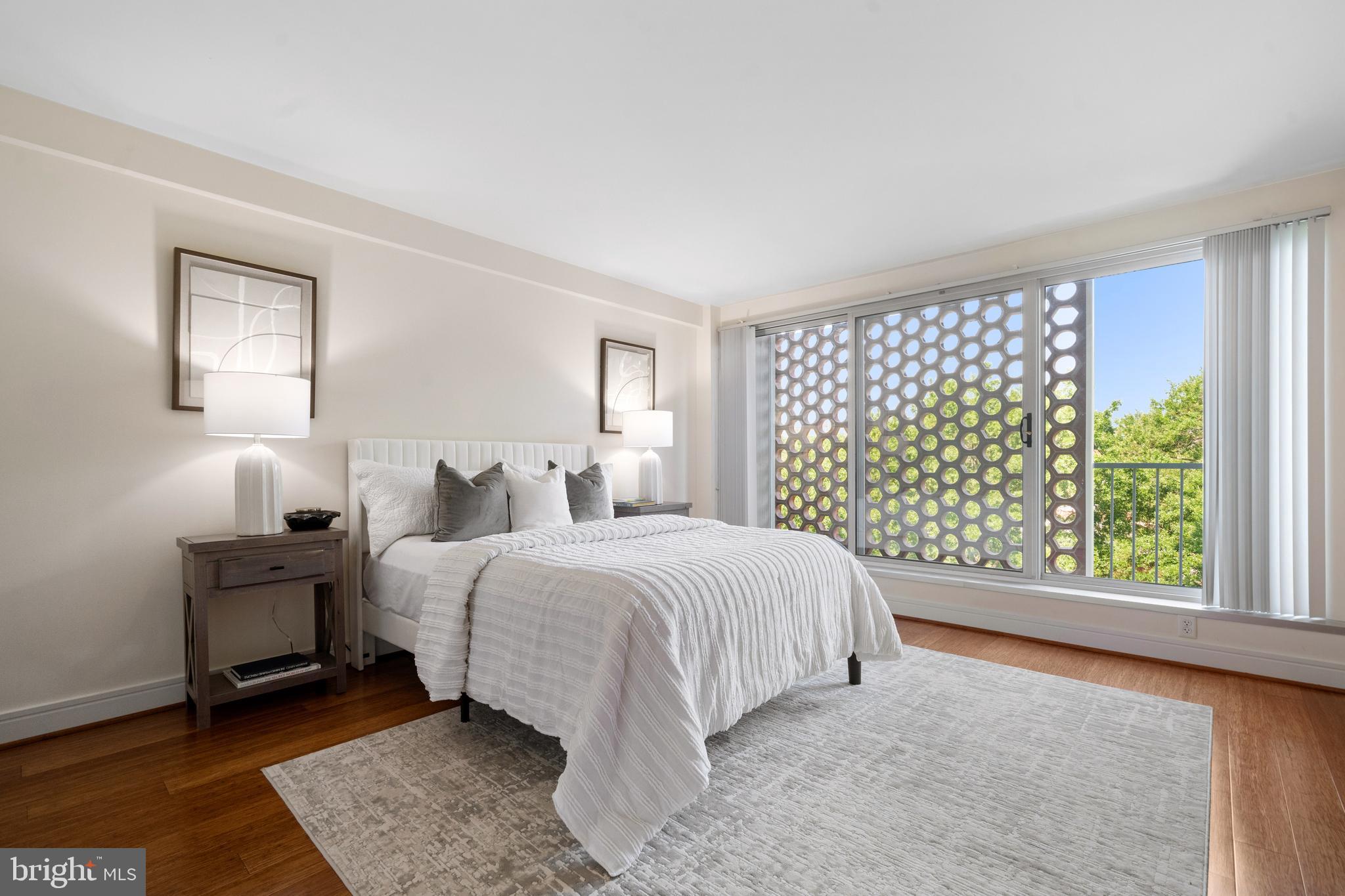 800 4th Street Southwest, Unit S421 Washington, DC 20024 - Photo 12 of 30 a large bed sitting in a bedroom next to a window