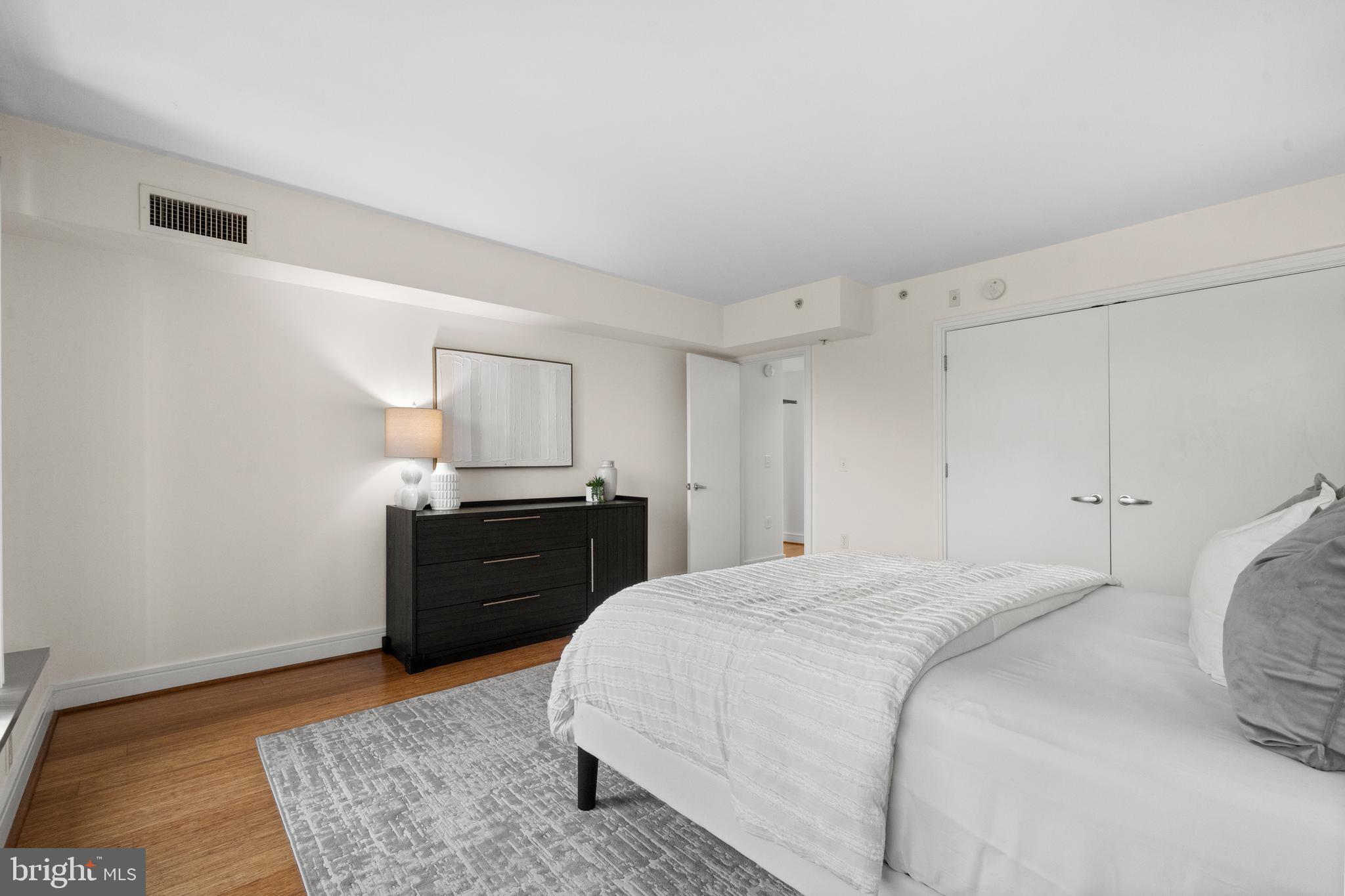 800 4th Street Southwest, Unit S421 Washington, DC 20024 - Photo 13 of 30 a bedroom with a bed and wooden floor