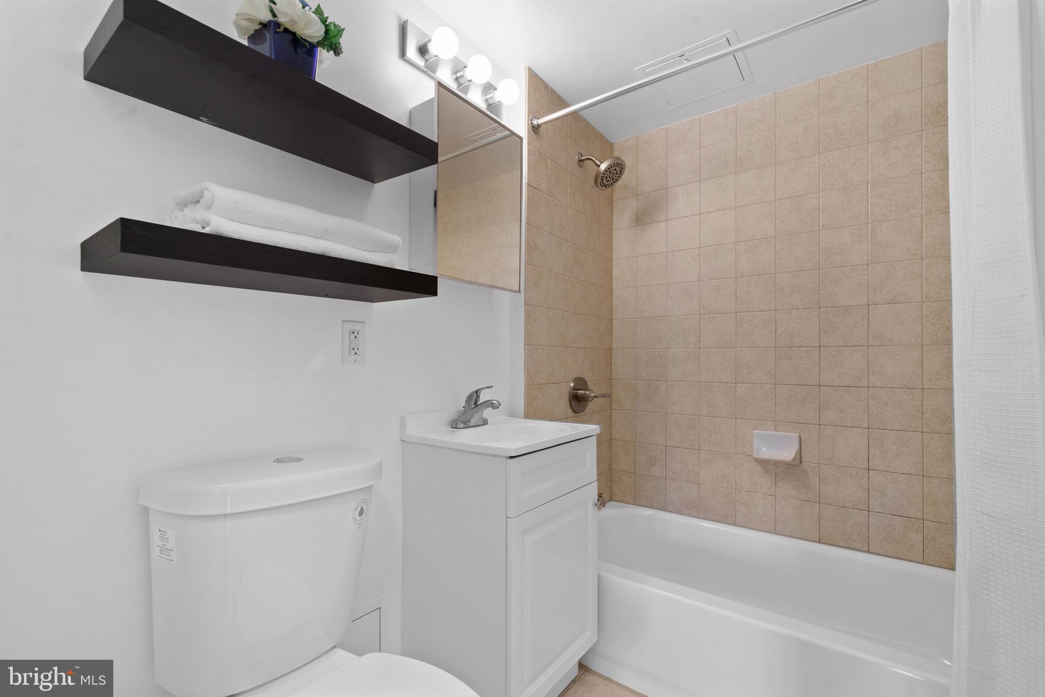 800 4th Street Southwest, Unit S421 Washington, DC 20024 - Photo 14 of 30 a bathroom with a sink a toilet and shower