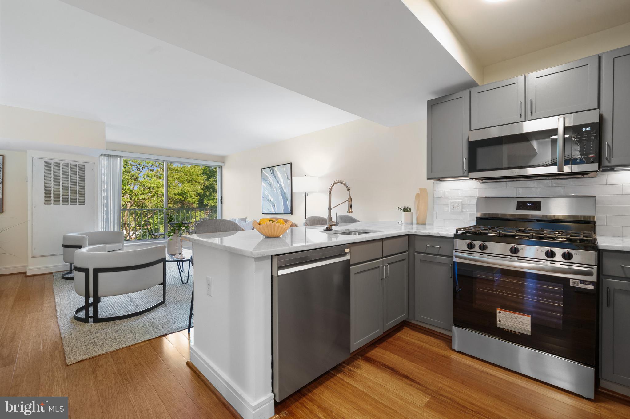800 4th Street Southwest, Unit S421 Washington, DC 20024 - Photo 3 of 30 a kitchen with stainless steel appliances a stove a sink and a microwave