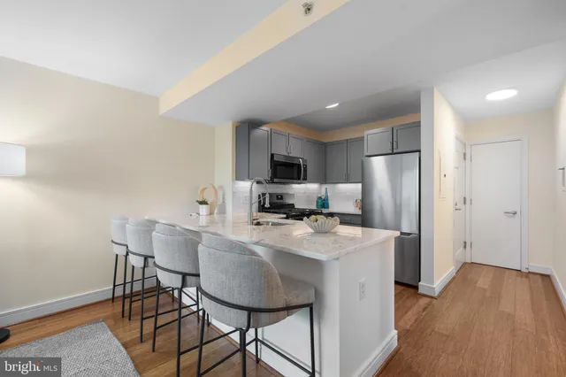 a view of kitchen with cabinets table and chairs