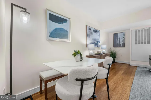 a living room with furniture and a dining table with kitchen view