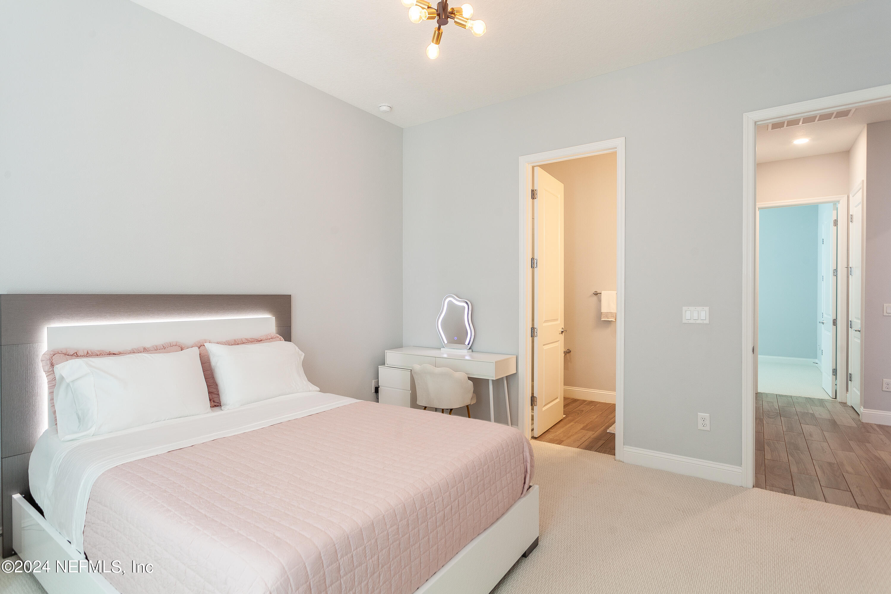 175 Caribbean Place St. Johns, FL 32259 - Photo 17 of 41 a bedroom with a bed and a chandelier