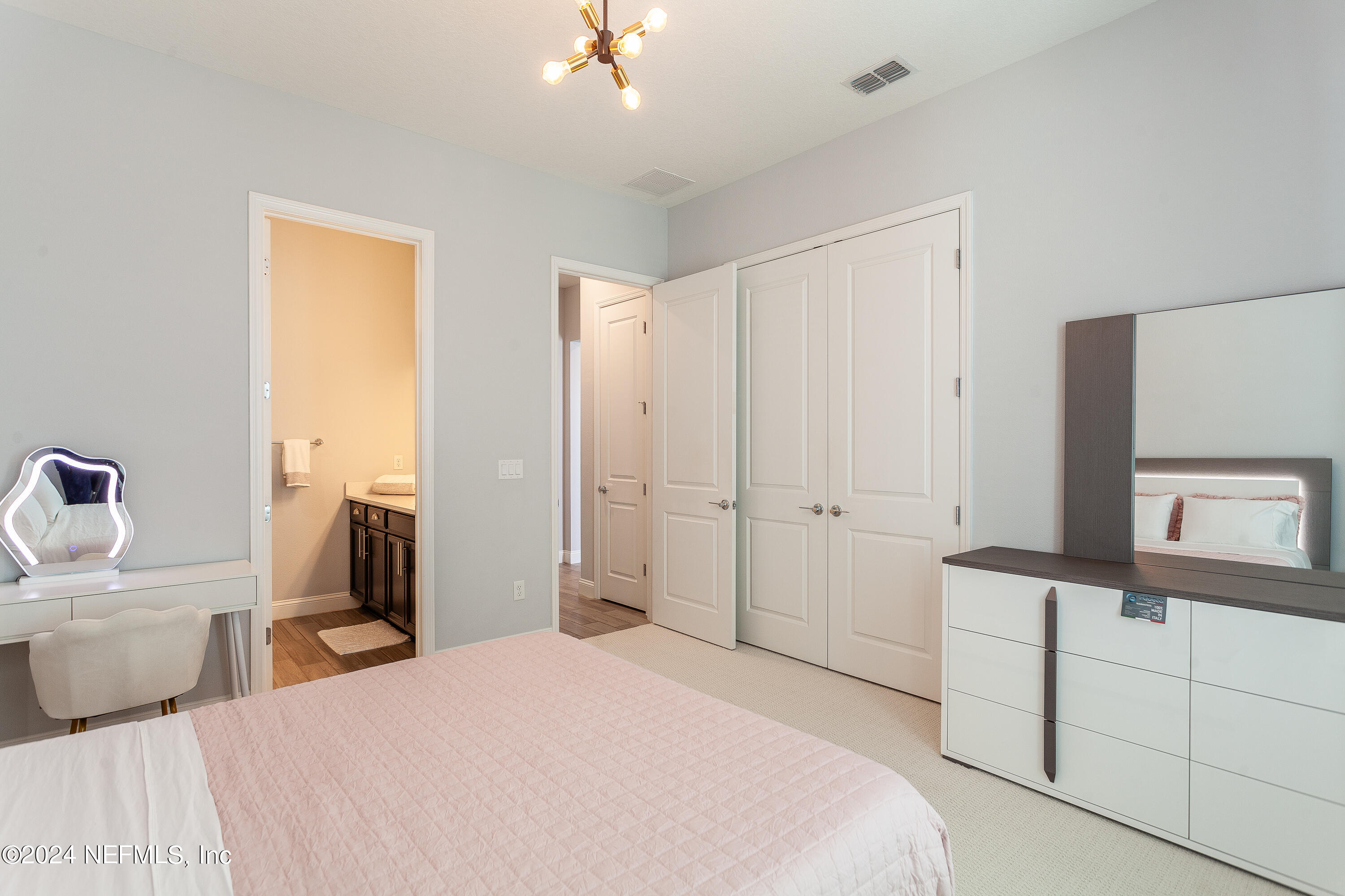 175 Caribbean Place St. Johns, FL 32259 - Photo 18 of 41 a bedroom with a bed and a flat tv screen on dresser