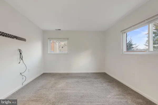 a view of room with window and air conditioner